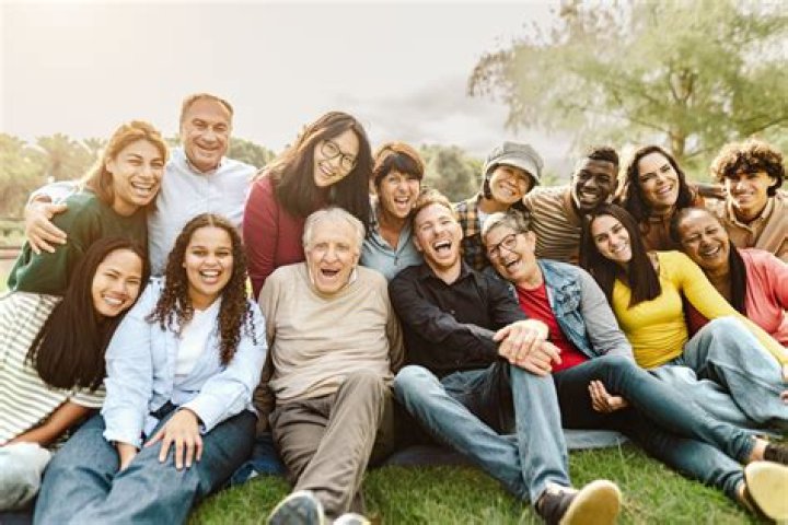 a group of people sitting on top of a couch in a living room next to