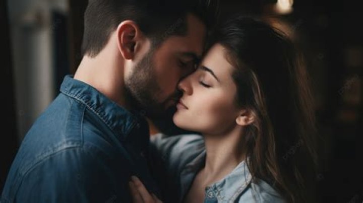 a man and woman kissing each other at an event