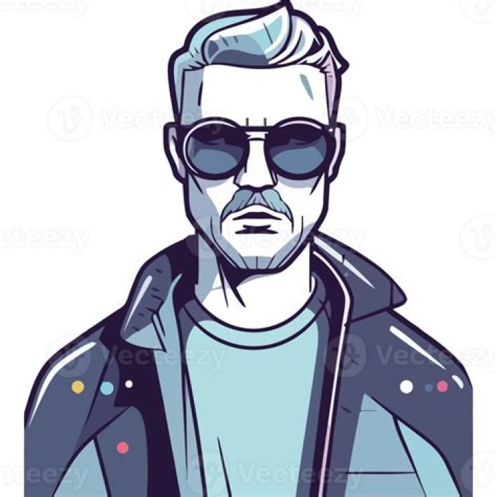 a man with sunglasses and a beard smiling at the camera while wearing a