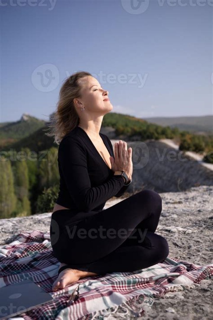 a woman is sitting on the floor with her tennis racket