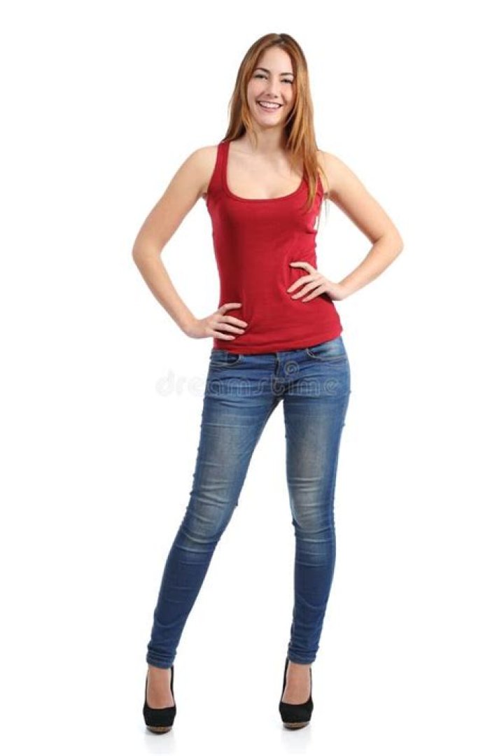 a woman standing in front of a window with her hands on her hips and