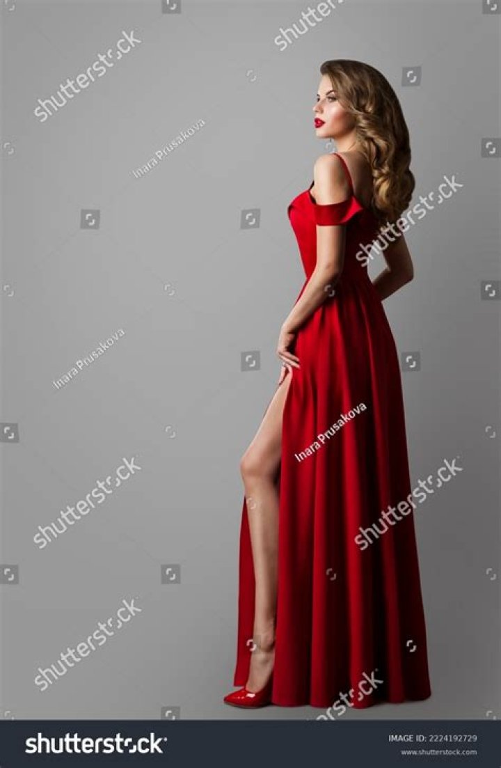 a woman wearing red knee high boots and a dress with flowers on it
