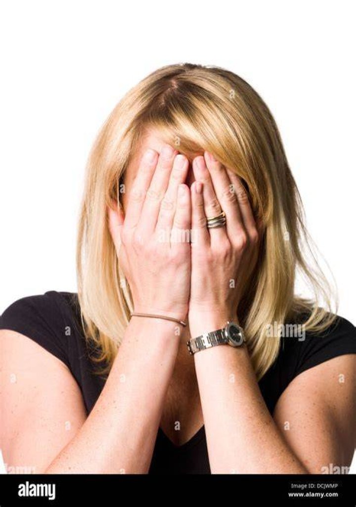 a woman with her hands up in front of her face, and the words spider
