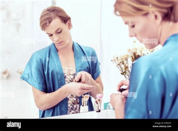Beautiful ginger transgender man getting ready for date night Stock