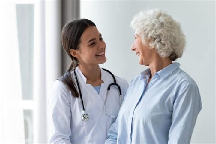Caring Millennial Nurse Helping Middle Aged Patient At Meeting. Stock