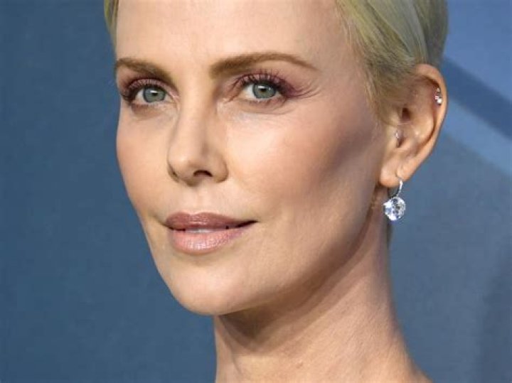 Charlize Theron reveals the popular '90s beauty trend she's 'still