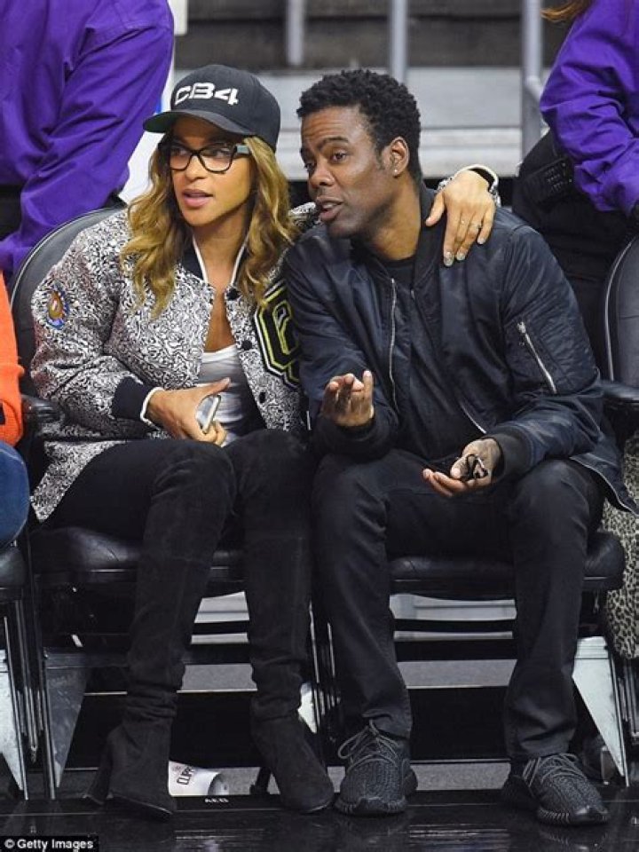 Chris Rock snuggles up to girlfriend Megalyn Echikunwoke at basketball