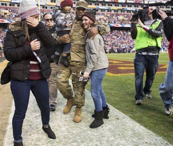 Jessica L. Watkins (left) wipes off her tears as her husband Spc. Leo