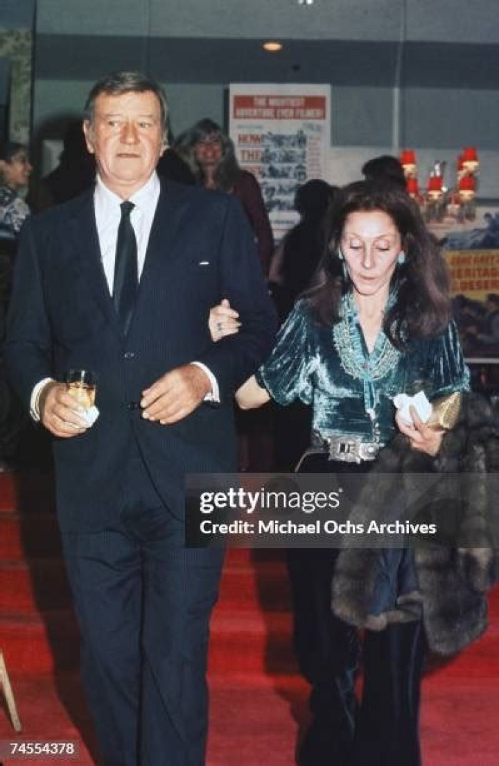 John Wayne and his wife Pilar attend a movie premiere in November