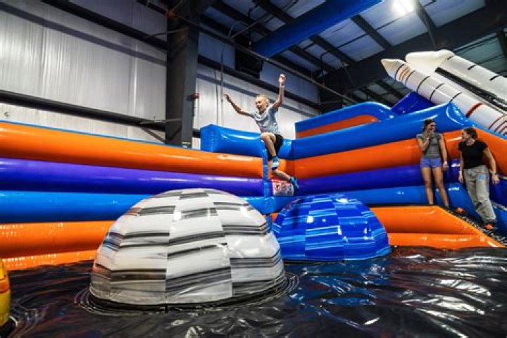 Jumping On A Trampoline Suspended Below A Hot Air Balloon Above The