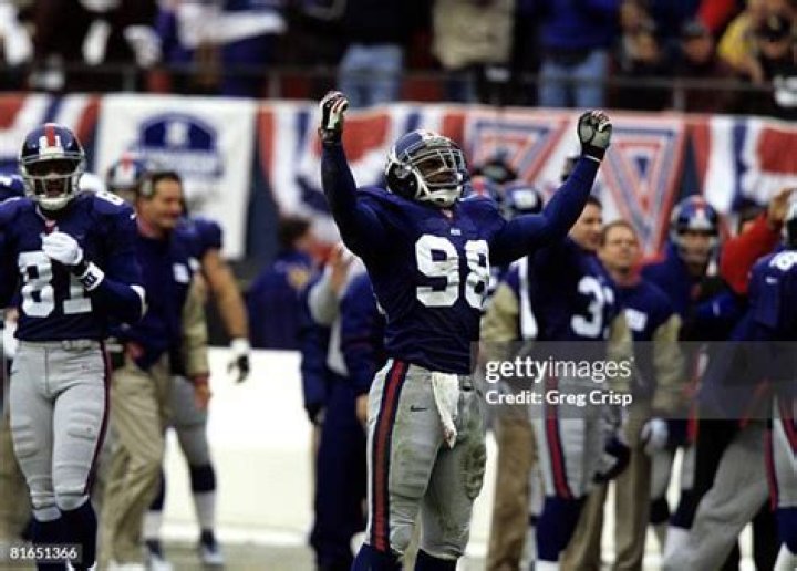 New York Giants linebacker Jessie Armstead of the NFC walk off the