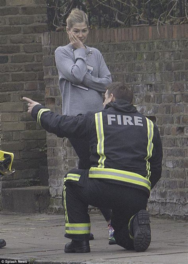 Rosamund Pike beams as her son Solo chats to a fireman near their London home Daily Mail Online