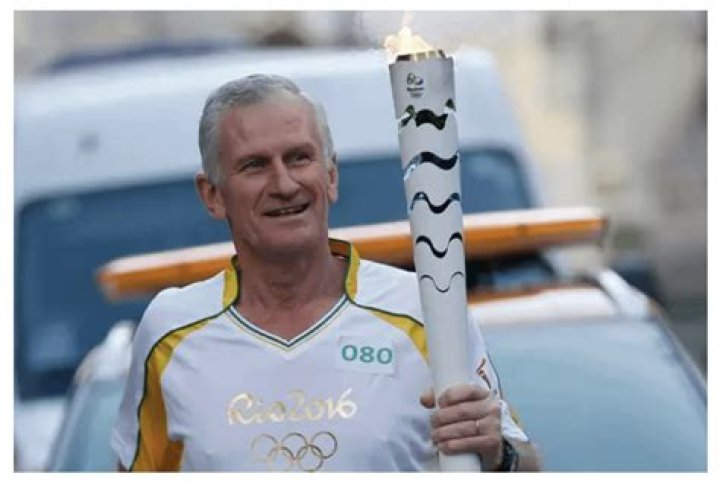 Roy Harley representing Uruguay and carrying the Olympic Torch en route