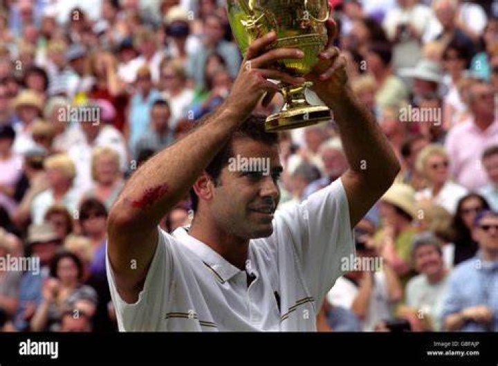 Sampras lifts the trophy and gains his seventh Wimbledon title.