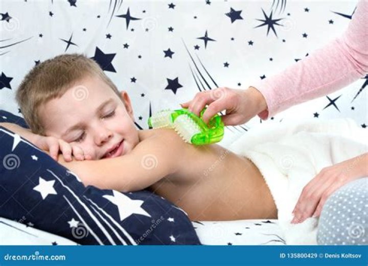 The Mother Makes the Massage of the Back of His Little Son. Stock Image