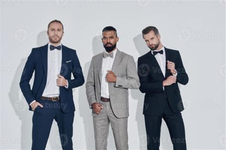 three men in suits standing next to each other