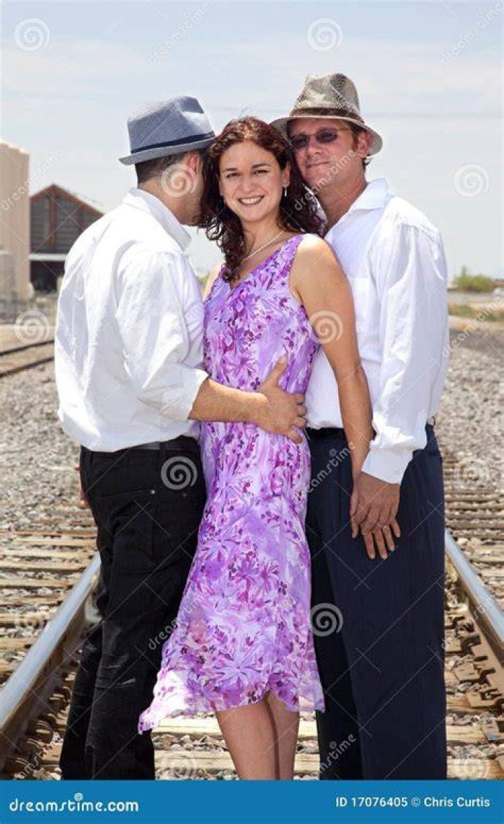two men and a woman standing next to each other