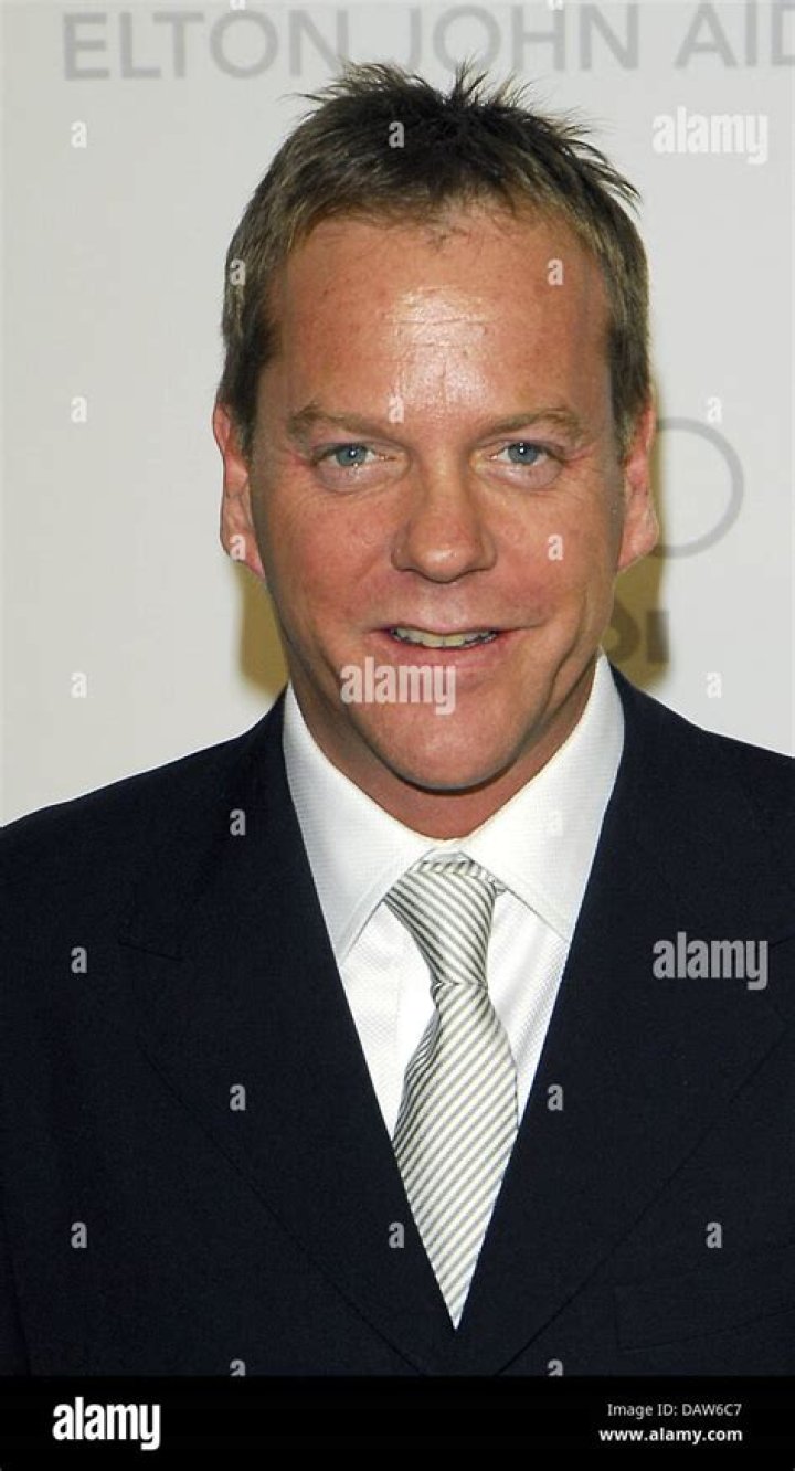 US actor Kiefer Sutherland smiles as hearrives for the Germany premiere